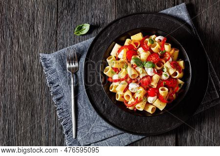 Roasted Pepper Tomato Mozzarella Pasta Salad In Black Bowl On Dark Oak Wood Table With Fork, Horizon