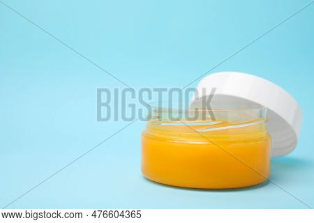Open Jar Of Petrolatum On Light Blue Background. Space For Text