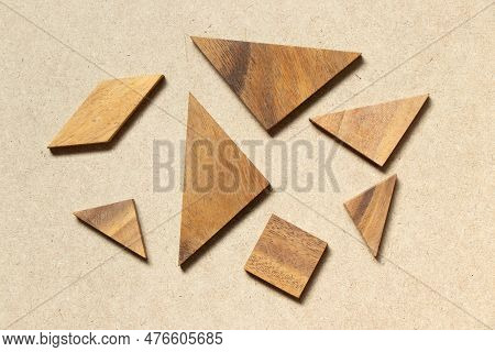 Straggled Tangram Puzzle  Wait To Complete The Shape On Wood Background
