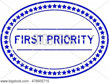 Grunge Blue First Priority Word Oval Rubber Seal Stamp On White Background