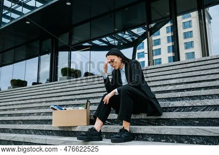 Woman Sitting On Steps, Lost In Thought About Her Jobless Situation And The Difficulty Of Finding Wo
