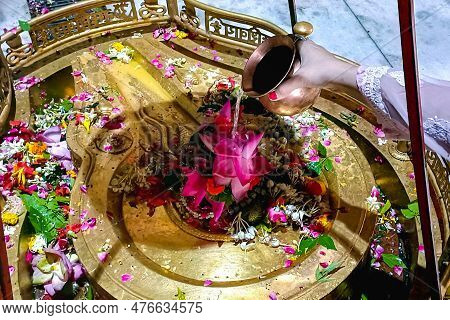 Hindu Devotees Offering Milk And Water To Shiv Lingam On Occasion Of Abhishekam In India . Offering 