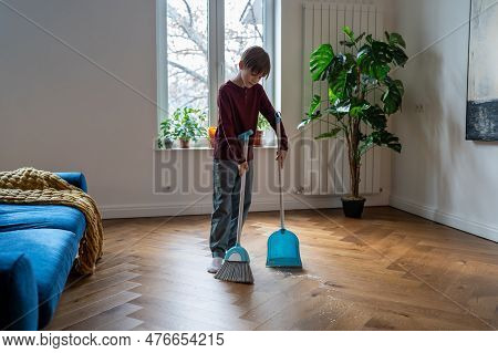 Household Chores For Children. Schoolboy Child Sweeping Floor. Kid Boy Holding Broom And Shovel Help