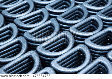 D-shaped Steel Rings Stacked In Close-up. Lots Of Steel Rings For Securing And Securing Heavy Indust