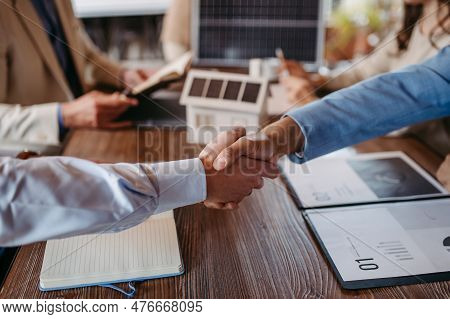 Close Up Of Businesmans Shaking Hands In Office.