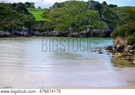 View On Playa De Poo During Low Tide Near Llanes, Green Coast Of Asturias, North Spain With Sandy Be
