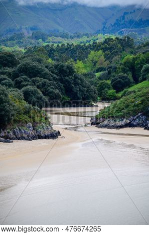 View On Playa De Poo During Low Tide Near Llanes, Green Coast Of Asturias, North Spain With Sandy Be