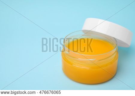 Open Jar Of Petrolatum On Light Blue Background. Space For Text