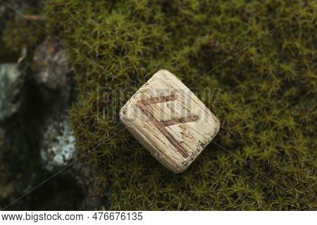 Wooden Rune Ansuz On Stone With Moss Outdoors, Closeup
