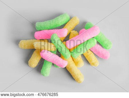 Pile Of Colorful Corn Puffs On Light Grey Background, Top View