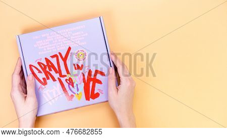 Hands Holds K-pop Group Itzy Crazy In Love 1St Album On Yellow Background. Special Edition Music Cd.
