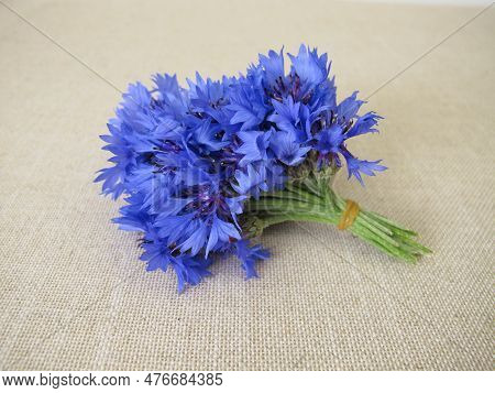 A Small Flower Bouquet With Cornflowers On Light Farbric