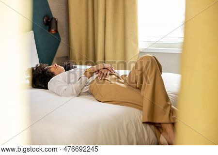 Young Woman Lying On Bed In The Hotel Rooma And Feeling Relaxed