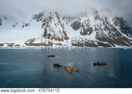 Extreme Tourism, Winter Kayaking In Antarctica And Arctic Greenaland, Adventurous Man Paddling On Se
