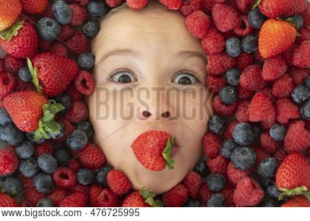 Kids Face With Close-up Berry. Berries Mix Of Strawberry, Blueberry, Raspberry, Blackberry. Assorted