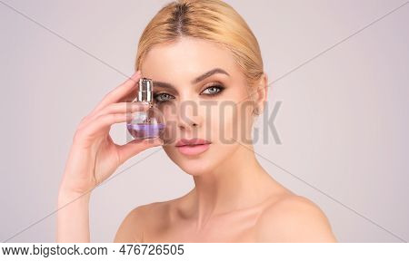 Beautiful Romantic Tender Girl Using Perfume. Woman With Bottle Of Perfume. Woman Presents Perfumes 