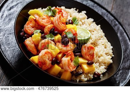 Caribbean Grilled Shrimps With Black Beans, Mango Pineapple Salsa Served With Brown Rice In Black Bo