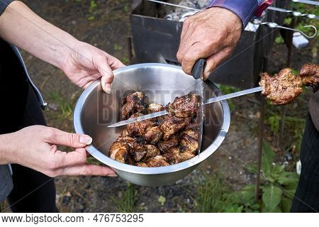 Ready To Eat. Put Fresh Cooked Appetizing Fried Kebab From Skewer Into A Bowl