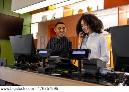 Team Of Receptionists Working At The Hotel Reception Desk