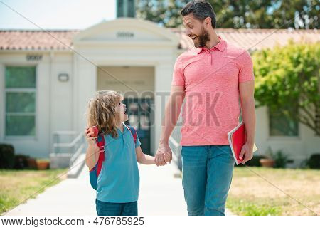 Father And Son Go To School, Education And Learning. Parent And Pupil Of Primary School Schoolboy Wi
