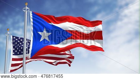 Flag Of Puerto Rico Waving With The United States Flag On A Clear Day. Puerto Rico Is A Caribbean Is