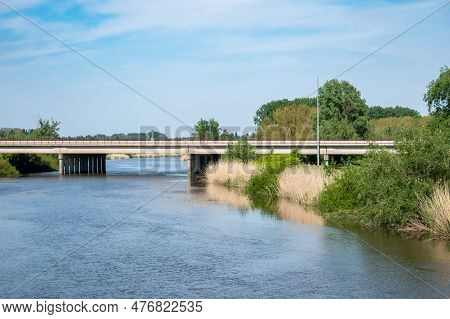 Hamme, East Flemish Region, Belgium - May 18, 2023 - Green Banks And Concrete Bridge Over The Old Du
