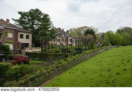 Uccle, Brussels Capital Region, Belgium - May 10, 2023 - Backyards Of Residences And A Green Hill At