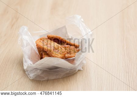 Kluay Khak Or Kluay Tod ( Banana Dipped ) In Fried Flour And Packed In Plastic Bags, A Popular Thai 