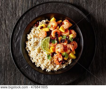 Caribbean Grilled Shrimps With Black Beans, Mango Pineapple Salsa Served With Brown Rice In Black Bo