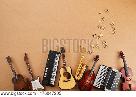 Happy World Music Day. Musical Instruments On Brown Background.