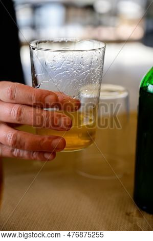 Tasting Of Natural Asturian Cider Made From fermented Apples In Cafe, Oviedo, Spain