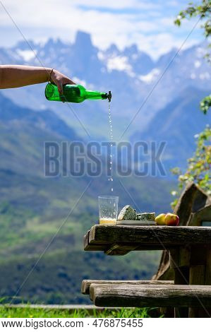 Pouring From High Height Of Natural Asturian Cider Made From fermented Apples, Asturian Cabrales Cow