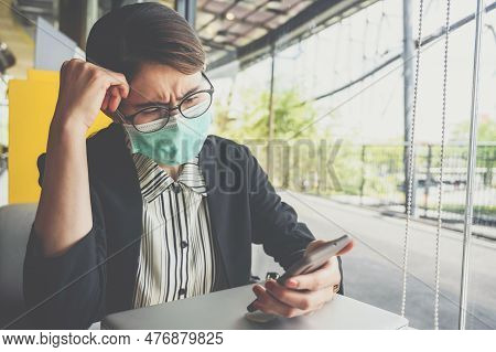 Asian Businesswoman Having Stressed While Looking Badnews From Her Mobile Phone. Conceptual Shot Of 