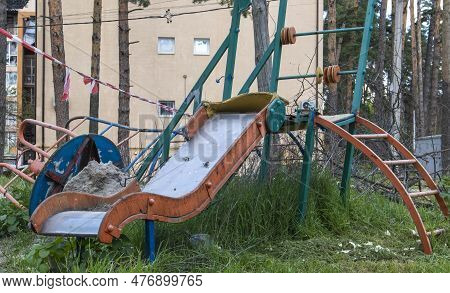 Affected After The Bombing Of Multi-storey Residential Buildings. A Playground Was Destroyed In Fron