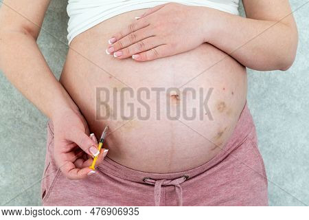 Blood Thinners Concept. Pregnant Woman Making Injection In Stomach