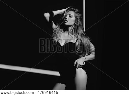 Woman In Shadow. Female Model With Shadows On Face Looking Seductive And Sensual On Dramatic Black S