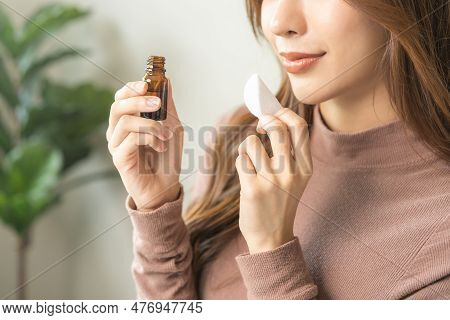 Aromatherapy, Asian Young Woman Hand Holding Cotton Pad, Bottle Of Essential Perfume Oil, Enjoying S