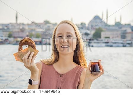 Woman In Istanbul Having Breakfast With Simit And A Glass Of Turkish Tea. Glass Of Turkish Tea And B