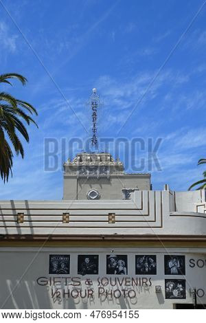 Hollywood, California - 12 May 2023: Hollywood Souvenirs Shop With The El Capitan Tower Rising Above