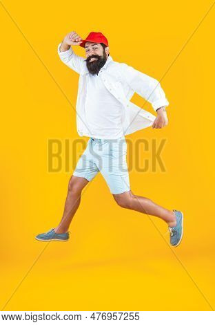 Hurrying Man Deliveryman Isolated On Yellow. Hurrying Man Deliveryman In Studio.