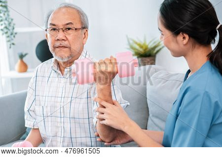 Unyielding Senior Patient Doing Physical Therapy With The Help Of His Caregiver. Senior Physical The