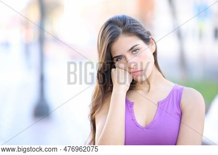 Bored Woman Looking At Camera Standing Alone In The Street
