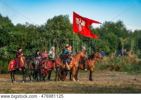 Gniew, Poland, Aug 2020 Polish Hussars And Nobility On Horses Under Polish Emblem With Eagle, Heavy 