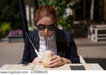 Blind Woman In Business Suit Drinking Ice Coffee In Outdoor Cafe.
