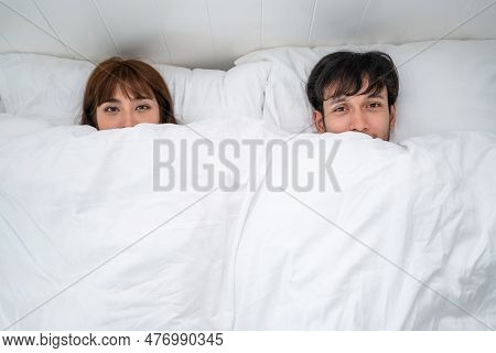 Happy Young Couple Relaxing At Home In The Morning.