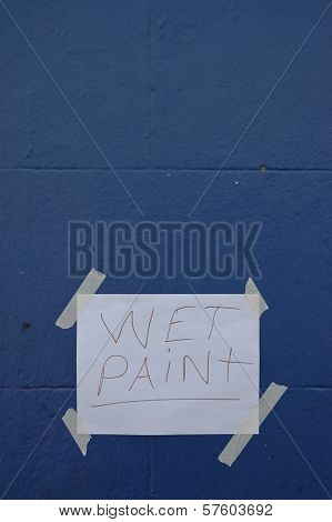 Wet Paint Paper Sign On Blue Wall