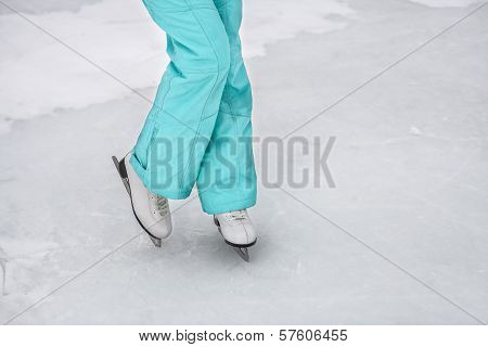 Young girl skating on the frozen lake