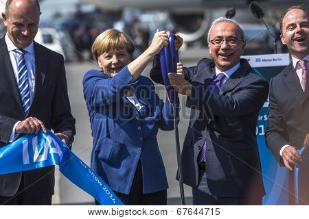 BERLIN, GERMANY - MAY 20, 2014: German Chancellor Angela Merkel, Turkish Minister of transport Lutfi Elvan and CEO Mr Christian (C.-R.) open up the International aviation and space exhibition ILA.