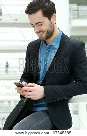 Young Man Dialling On Mobile Phone