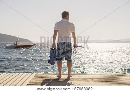 man with fins and mask